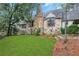 Stone house with a lush green lawn and mature trees at 6 Arden Moor Nw, Atlanta, GA 30305