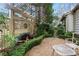 Serene garden with water feature, decorative lattice, manicured hedges, and seating area at 6 Arden Moor Nw, Atlanta, GA 30305