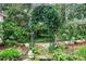 Lush garden featuring a charming vine-covered archway and stone path at 6 Arden Moor Nw, Atlanta, GA 30305