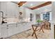 Charming kitchen with white cabinets, stainless steel appliances, and a small dining area at 6 Arden Moor Nw, Atlanta, GA 30305