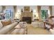Cozy living room featuring a stone fireplace, neutral furniture, and natural light at 6 Arden Moor Nw, Atlanta, GA 30305