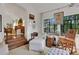 Comfortable living room featuring an armchair, a rocking chair, and steps up to the piano at 6 Arden Moor Nw, Atlanta, GA 30305