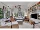 Comfortable living room featuring built-in bookshelves and bright windows at 6 Arden Moor Nw, Atlanta, GA 30305