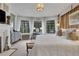 Light-filled main bedroom with fireplace, desk, and backyard views at 6 Arden Moor Nw, Atlanta, GA 30305