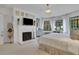Light-filled main bedroom with fireplace, desk, and backyard views at 6 Arden Moor Nw, Atlanta, GA 30305