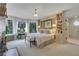 Bright main bedroom with bookshelves, sitting area, and large windows at 6 Arden Moor Nw, Atlanta, GA 30305