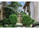 Charming side yard featuring lush greenery, stone pathway, and quaint garden details at 6 Arden Moor Nw, Atlanta, GA 30305