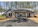 Inviting exterior featuring gray vertical siding, stone accents, and a cozy covered entryway at 835 Old Brock Rd, Rockmart, GA 30153