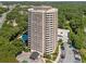 High-rise condo building with surrounding trees and parking at 1501 Clairmont Rd # 223, Decatur, GA 30033