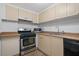 Beige cabinets, stainless steel appliances, and tile floor at 1501 Clairmont Rd # 223, Decatur, GA 30033