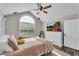 Bright bedroom featuring a comfy bed, large TV, and ample closet space at 418 Kenley Ct, Mcdonough, GA 30253