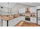 Modern kitchen with white cabinets, granite countertops, and stainless steel appliances at 418 Kenley Ct, Mcdonough, GA 30253