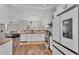 Open kitchen with island, stainless steel appliances, and hardwood floors at 418 Kenley Ct, Mcdonough, GA 30253
