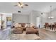 Open living area with hardwood floors and leather sectional sofa at 418 Kenley Ct, Mcdonough, GA 30253