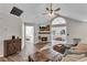 Open living room with fireplace, hardwood floors, and access to bedroom and sunroom at 418 Kenley Ct, Mcdonough, GA 30253