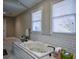Soaking tub with white subway tile surround in a spacious bathroom at 1496 Sweet Bottom Sw Cir, Marietta, GA 30064