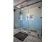 Spacious walk-in shower with glass doors and hexagon tile floor at 1496 Sweet Bottom Sw Cir, Marietta, GA 30064