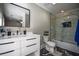 Modern bathroom with white vanity, marble shower, and dark floors at 1496 Sweet Bottom Sw Cir, Marietta, GA 30064