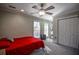 Bedroom with red bedding, ceiling fan, and double-door closet at 1496 Sweet Bottom Sw Cir, Marietta, GA 30064