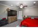 Spacious bedroom with large TV, dresser, and red bedding at 1496 Sweet Bottom Sw Cir, Marietta, GA 30064