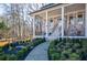 Covered front porch with brick columns and landscaping at 1496 Sweet Bottom Sw Cir, Marietta, GA 30064