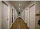 Long hallway with hardwood floors and access to multiple rooms at 1496 Sweet Bottom Sw Cir, Marietta, GA 30064