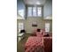 Spacious living area featuring a pink sectional sofa and large windows at 1496 Sweet Bottom Sw Cir, Marietta, GA 30064