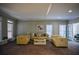 Living room with light yellow sofas and a fireplace at 1496 Sweet Bottom Sw Cir, Marietta, GA 30064