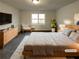 Virtually staged main bedroom with large bed and sitting area at 4620 Cedar Brook Se Dr, Conyers, GA 30094