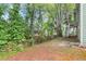 Backyard with wooden fence, foliage, and a set of stairs leading to an elevated area at 5076 Furlong Way, Powder Springs, GA 30127