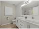 Bright bathroom featuring a double sink vanity, modern fixtures, and a large mirror at 5076 Furlong Way, Powder Springs, GA 30127