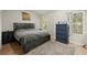 Bedroom with a bed, bedside table, dresser, and two windows at 5076 Furlong Way, Powder Springs, GA 30127