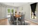 Formal dining room with a wood table, six gray chairs, white buffet, and a glass door to the back porch at 5076 Furlong Way, Powder Springs, GA 30127