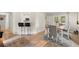 Bright dining room with wood floors, seating for six, and sliding glass doors to the backyard at 5076 Furlong Way, Powder Springs, GA 30127