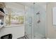 Shower stall featuring glass doors, a shower head, and tile surround at 5076 Furlong Way, Powder Springs, GA 30127