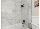 Updated shower with marble tile, glass enclosure and black shower head at 5076 Furlong Way, Powder Springs, GA 30127