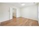 Well-lit bedroom with hardwood floors and double door entry at 718 Surrey Park Se Pl, Smyrna, GA 30082