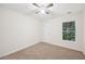 Spacious bedroom with ceiling fan and neutral colored carpet at 718 Surrey Park Se Pl, Smyrna, GA 30082