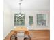 Bright dining area with hardwood floors, chandelier and patio access at 718 Surrey Park Se Pl, Smyrna, GA 30082