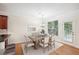 Virtually staged dining room with large table and access to a patio at 718 Surrey Park Se Pl, Smyrna, GA 30082