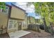 Townhome back exterior view, small patio, fenced yard, and trees at 718 Surrey Park Se Pl, Smyrna, GA 30082