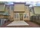 Tan townhome with a small patio, fenced yard, and central air conditioning unit at 718 Surrey Park Se Pl, Smyrna, GA 30082