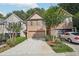 Brick front of townhome with 2-car garage and landscaping at 718 Surrey Park Se Pl, Smyrna, GA 30082