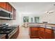 Modern kitchen with island, stainless steel appliances, and view to dining area at 718 Surrey Park Se Pl, Smyrna, GA 30082