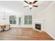 Living room with hardwood floors, fireplace and access to patio at 718 Surrey Park Se Pl, Smyrna, GA 30082