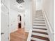 Hardwood staircase with white risers and neutral walls at 718 Surrey Park Se Pl, Smyrna, GA 30082