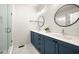 Modern bathroom featuring a double vanity with blue cabinets and walk-in shower at 720 Perch Pl, Atlanta, GA 30312
