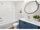 Stylish bathroom with tub, and single sink vanity with vibrant blue cabinets at 720 Perch Pl, Atlanta, GA 30312