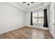 Spacious bedroom with hardwood floors, tray ceiling, fan, and abundant natural light at 720 Perch Pl, Atlanta, GA 30312