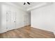 A bedroom with hardwood floors and crisp white walls with two door access points at 720 Perch Pl, Atlanta, GA 30312